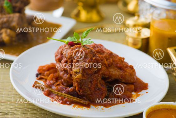 curry chicken cooked in indian style with spicy sauce and chilli