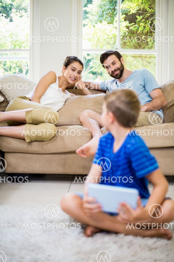 Parents talking to a son while using laptop
