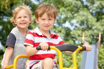 Two Young Boys Playing on Bike