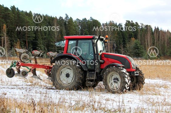 Red Tractor on Field in Early Winter