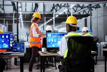 Young people learning modern automation technology using...