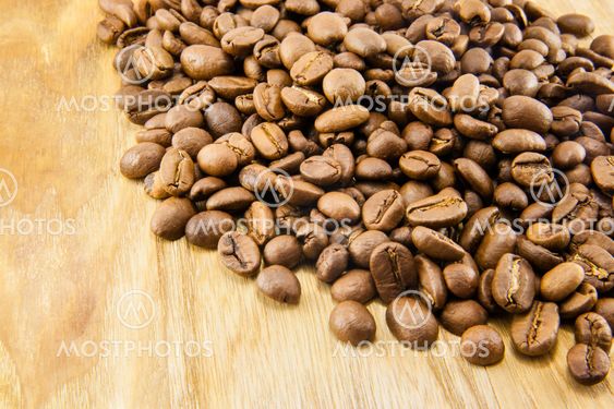 Coffee beans on vintage wooden board