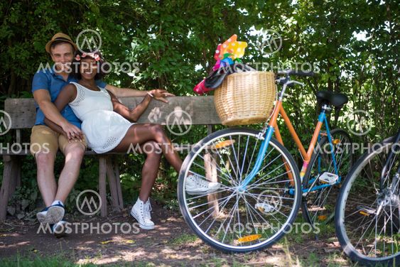 Young multiethnic couple having a bike ride in nature