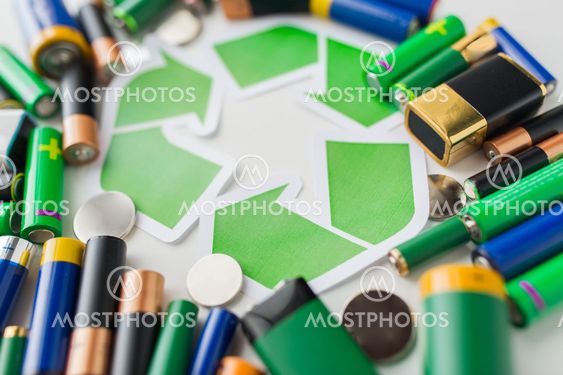 close up of batteries and green recycling symbol