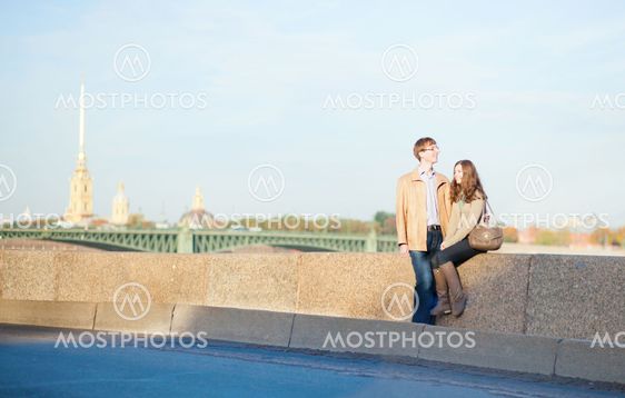 Happy smiling couple in Saint-Petersburg, with Peter and Paul Fortress in the background