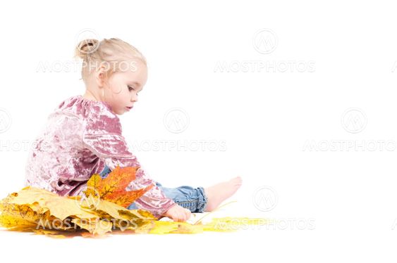 Toddler with maple leaves