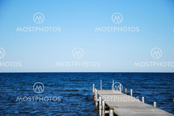 Wooden bath pier in blue water