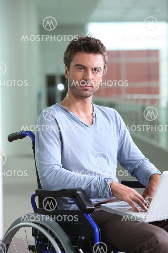 Man on laptop in wheelchair
