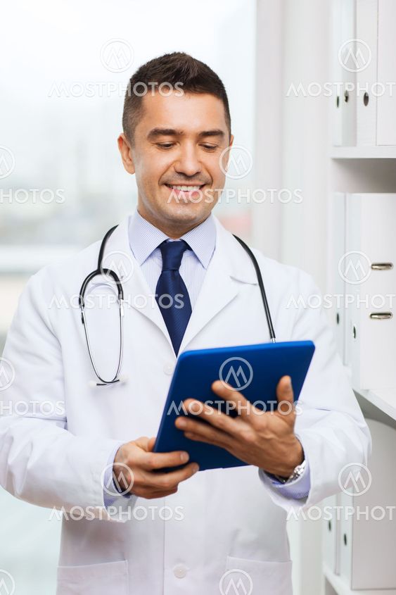 smiling male doctor in white coat with tablet pc