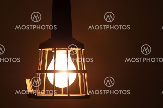Vintage old bulb, rustic barn lamp light glows in the dark