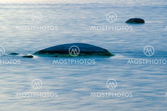 Rocks in soft blue water