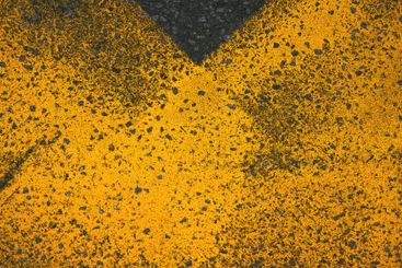 Yellow paint road marking on asphalt highway surface,...