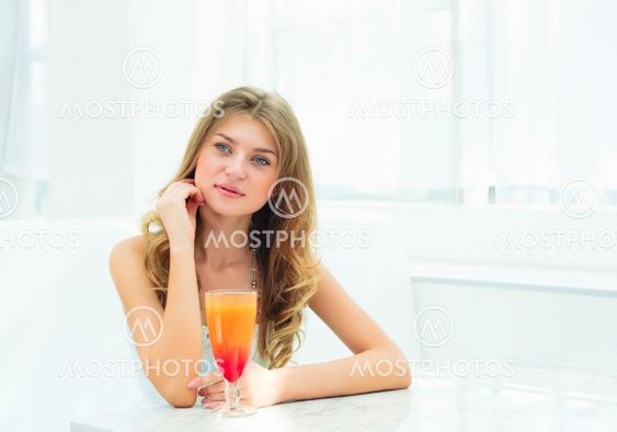 Portrait of a cute woman in a city cafe