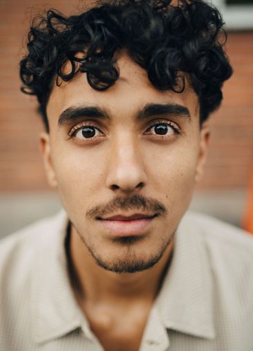 Portrait of young man with curly hair