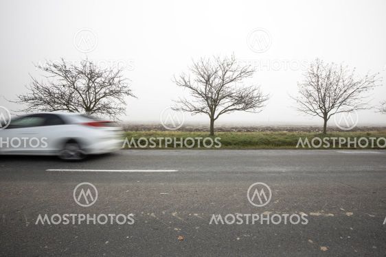 Motion blurred truck going fast on a rural road