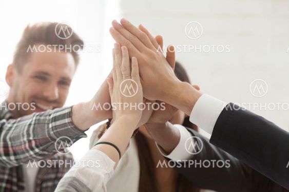 Close up of colleagues giving high five celebrating successful s