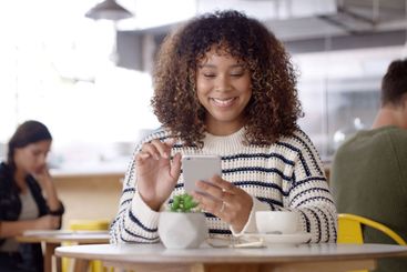Cellphone, happy and woman with coffee in cafe reading...