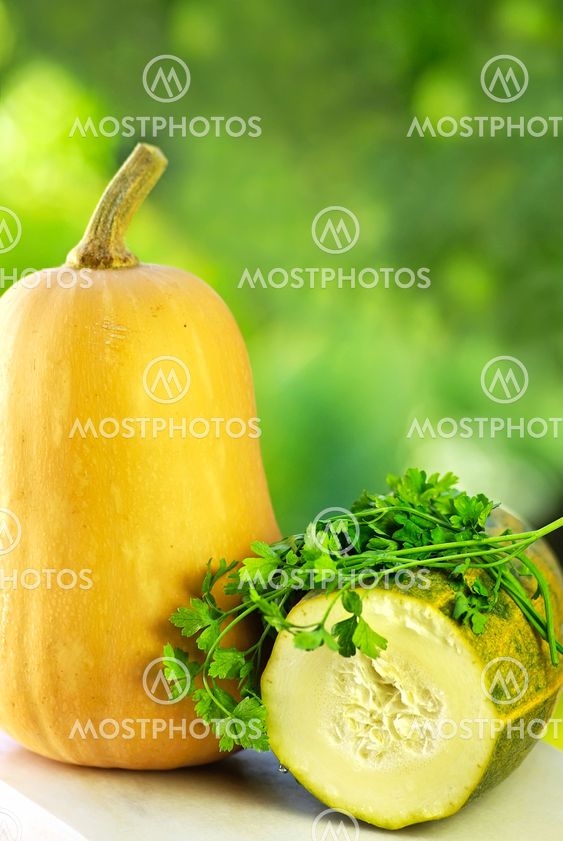 Pumpkin and courgete on table.