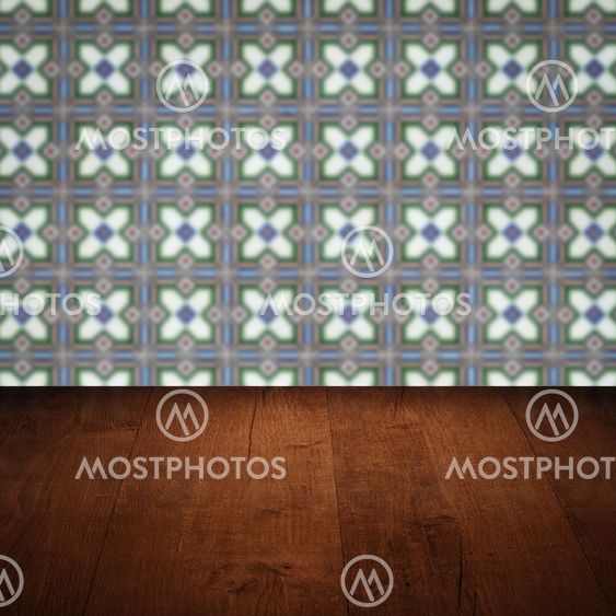 Wood table top and blur vintage ceramic tile pattern wall