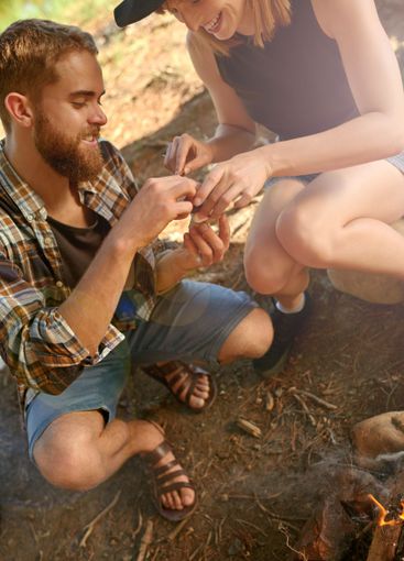 Happy, couple and eating roast marshmallow in fun...