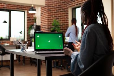 Businesswoman using greenscreen laptop