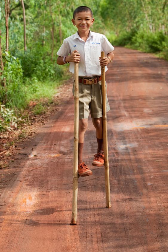 Boy goes on stilts