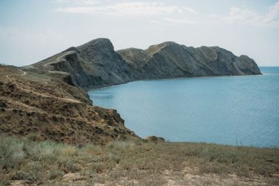 Scenic calm seashore with Crimean mountains ridge,...