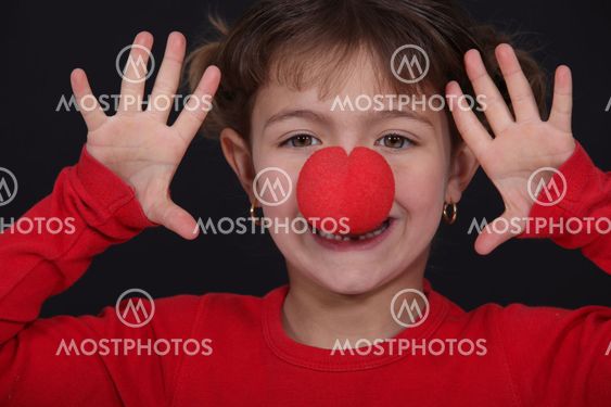 little girl with red nose playing clown