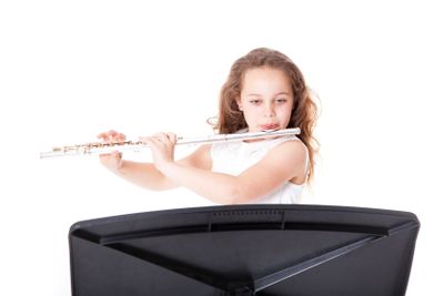 young  girl playing flute