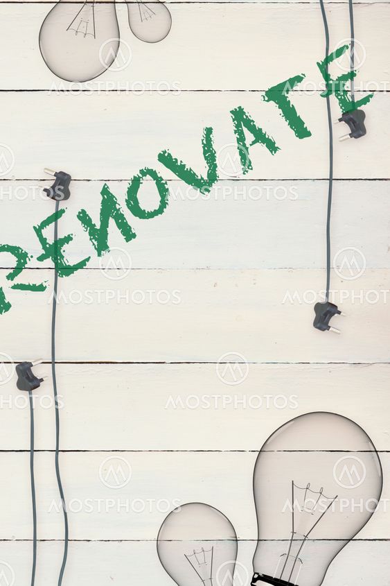 Renovate against bulb on wooden background