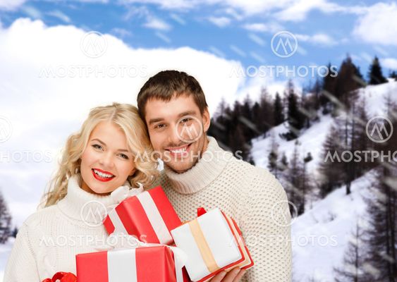 smiling man and woman with presents