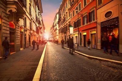 people walking on wall street with european building...