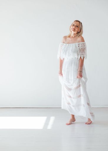 Beautiful blonde woman in summer white wedding dress