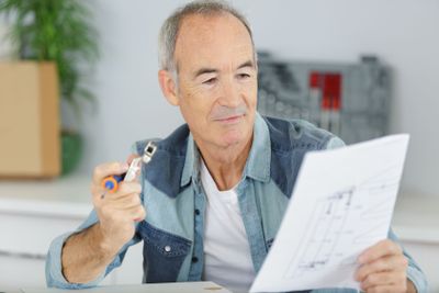 construction man checking the plans at home