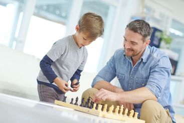 Chess, learning or strategy with father and son in...