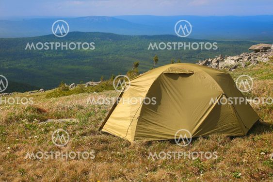 tourist tent on hill in mountains