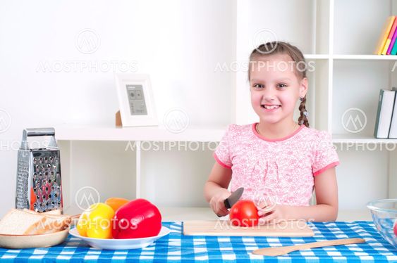 girl working in the kitchen cutting vegetables