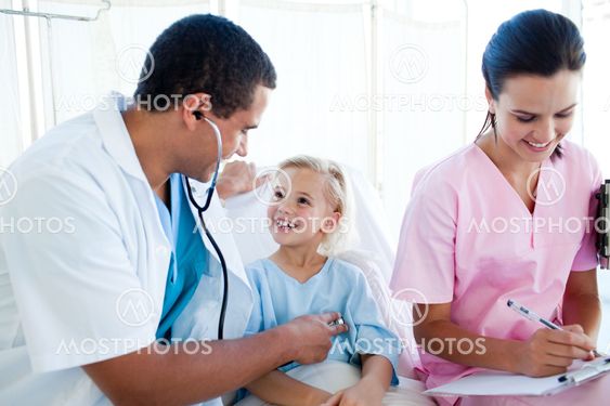Male doctor and female nurse examining a child patient
