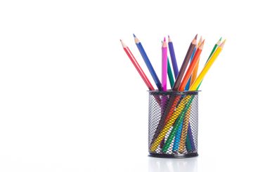 Colorful pencils arranged in a black holder on a white...