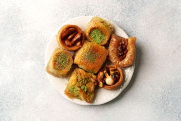 Traditional Middle Eastern desserts served on a white...