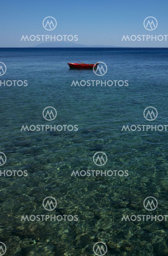 red boat moored alone in the sea