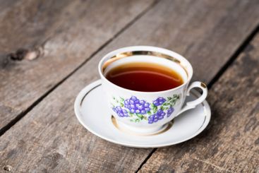 Closeup of cup of tea on vintage wooden background