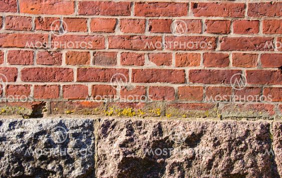 Background red brick wall stone house foundations