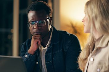 Laptop, advice and business people together at night for...