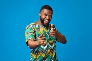 Cheerful black guy in traditional african clothes...