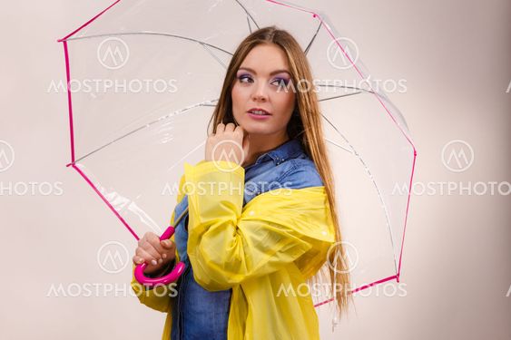 Woman wearing waterproof coat holding umbrella