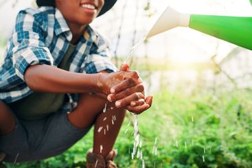 Bacteria, washing hands and watering can with people on...