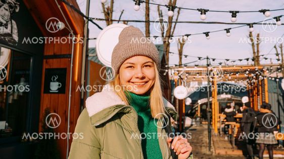 Young blonde at the European street food fair. She is happy