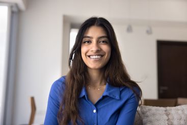 Head shot portrait beautiful Indian woman looking at camera