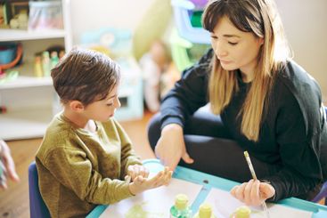 Learning, painting or art with a mother and son in a...